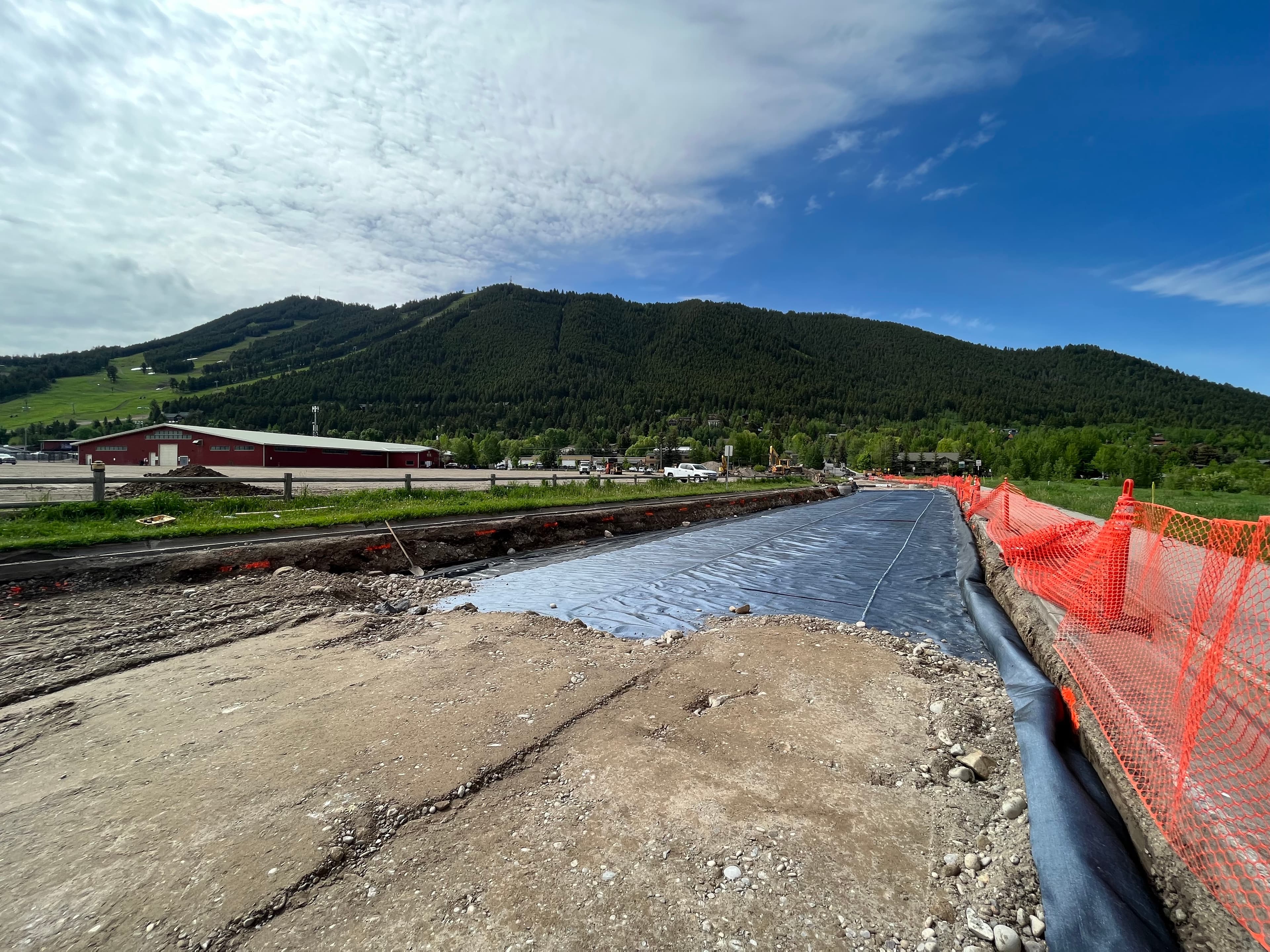 The geosynthetic layer was terminated into a trench system, allowing captured moisture to flow into a dry well through controlled drainage.