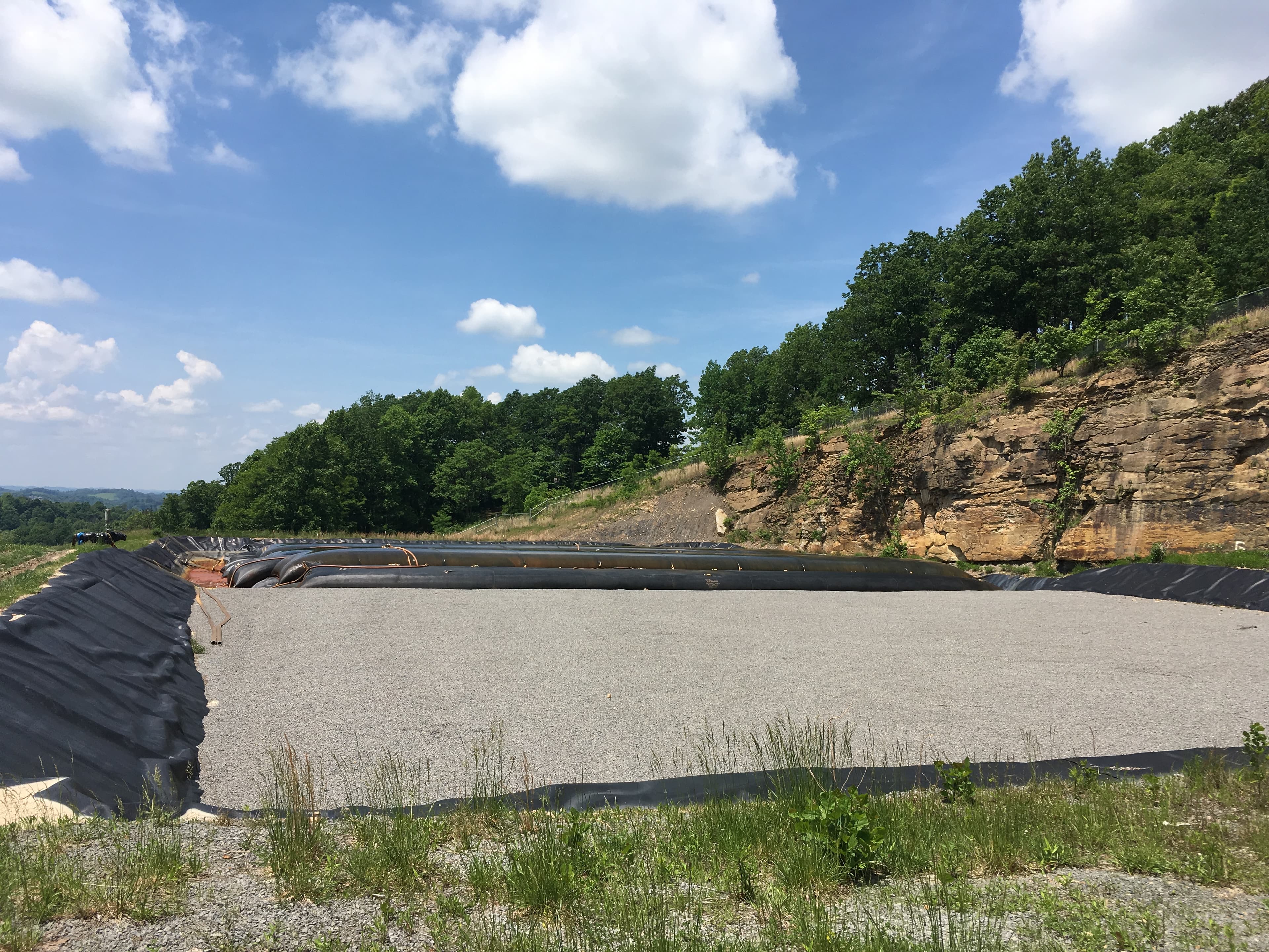 GEOTUBE containers piled next to a new dewatering site.