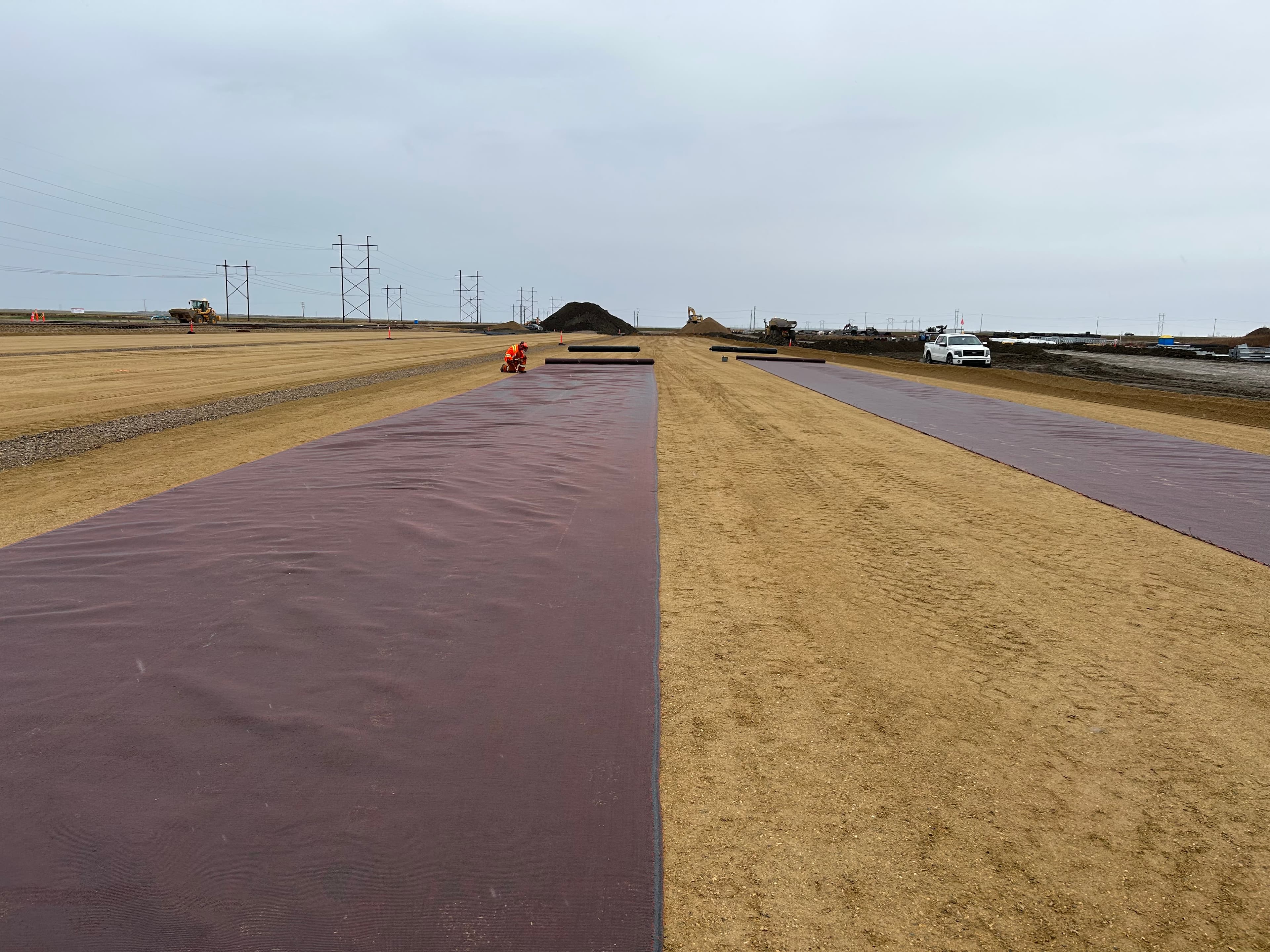 MIRAFI RS580i woven geotextile reinforced the ballast layer, decreasing sub-ballast thickness by 55%, resulting in cost-effective railway construction. The geosynthetic-stabilized road structure integrated MIRAFI and followed AASHTO 93 guidelines, achieving a 20% cost reduction while enhancing durability