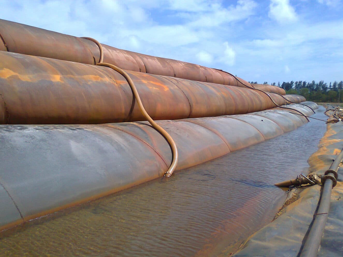 Industrial waste, often in slurry form and containing contaminants, needs to be managed and disposed of properly to protect the environment.