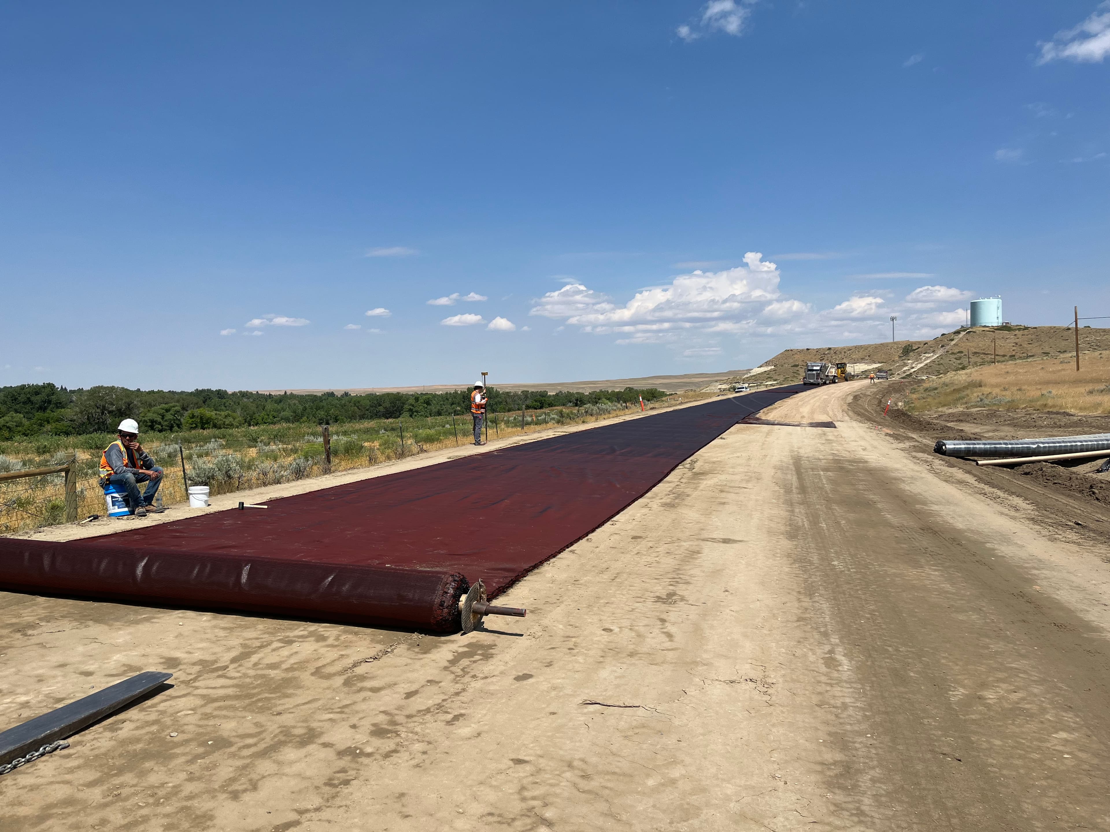 The geosynthetic was secured to the subgrade to resist strong winds during installation.